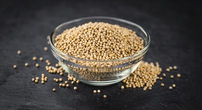 Portion of Seeds (Mustard) on a rustic slate slab (selective focus, close-up shot)