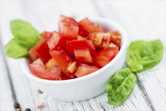 Homemade Cutted Tomatoes on vintage background (selective focus, close-up shot)