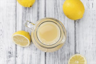 Lemon Juice on a vintage background as detailed close-up shot (selective focus)