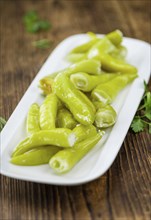 Fresh made Green Chilis (filled with cheese) on a vintage background (close-up shot)