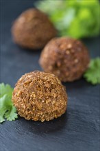 Portion of Falafel on an old wooden table (close-up shot, selective focus)