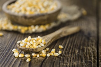 Portion of Corn (detailed close-up shot) on wooden background (selective focus)