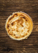 Fresh made Mini Cheesecake on an old and rustic wooden table (selective focus, close-up shot)