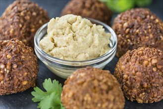 Homemade Falafel (close-up shot, selective focus) on wooden background