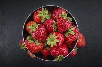 Some Strawberries on a slate slab as detailed close-up shot, selective focus