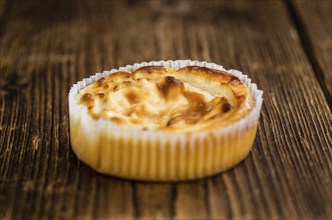 Homemade Cheesecake on an wooden table (selective focus) as detailed close-up shot