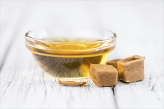 Caramel Sirup on a vintage background as detailed close-up shot (selective focus)
