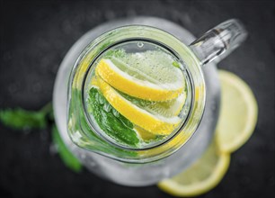 Some Lemonade (with Balm) on a slate slab (close-up shot, selective focus)