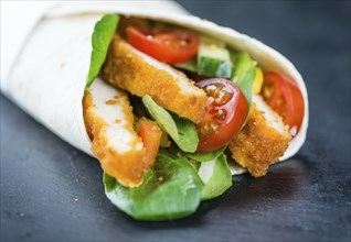 Fresh made Chicken Wraps on an vintage background (selective focus)