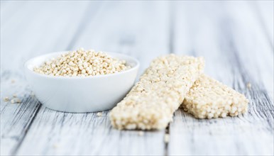 Quinoa Bars on a wooden table as detailed close-up shot (selective focus)