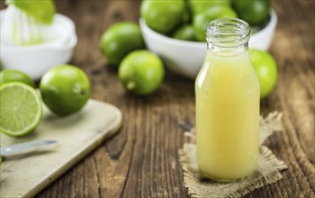 Portion of fresh Lime Juice (close-up shot, selective focus)