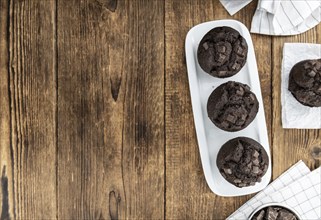 Some fresh Chocolate Muffins (selective focus, close-up shot)