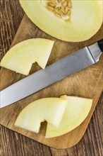 Fresh made Honeydew Melon on a vintage background (close-up shot)