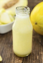 Healthy Honeydew Melon Smoothie (selective focus) on an old wooden table