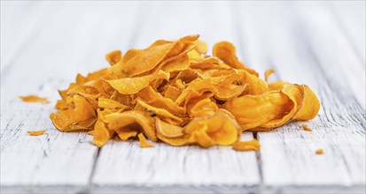 Homemade Sweet Potato Chips on vintage background selective focus, close-up shot