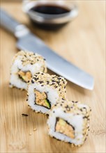 Portion of Sushi on a wooden table (selective focus, close-up shot)