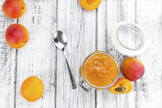 Fresh made Apricot Jam on a vintage background (close-up shot)