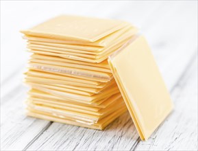 Sliced Cheese on a vintage background as detailed close-up shot (selective focus)