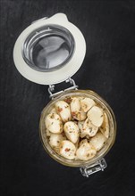 Portion of fresh Preserved Garlic (close-up shot, selective focus)