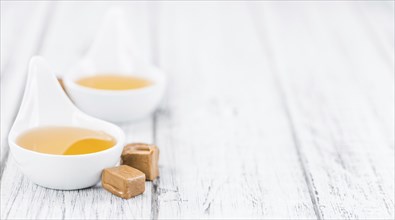 Caramel Sirup on a vintage background as detailed close-up shot (selective focus)