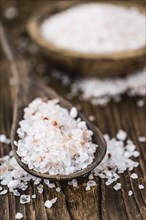 Pink Salt on a vintage background as detailed close-up shot (selective focus)