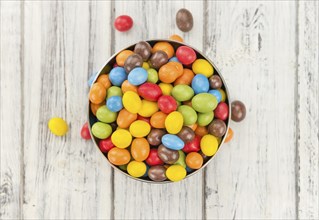 Cocolate coated Peanuts on a vintage background as detailed close-up shot (selective focus)