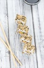 Portion of Sushi on a wooden table (selective focus, close-up shot)