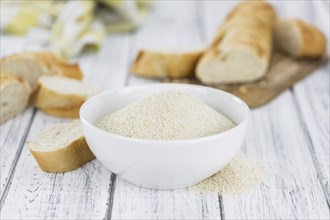 Some Bread Crumbs on a vintage wooden table (selective focus, close-up shot)