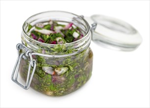 Chimichurri as detailed close-up shot isolated on white background (selective focus)