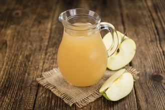 Apple Juice on a vintage background as detailed close-up shot (selective focus)