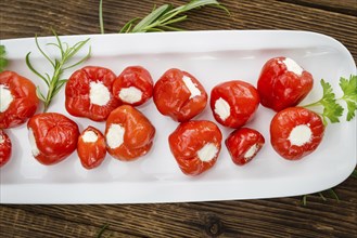 Homemade Filled Pimientos on vintage background (selective focus, close-up shot)