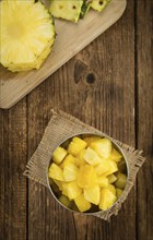 Fresh made Pineapple (sliced) on a vintage background as detailed close-up shot