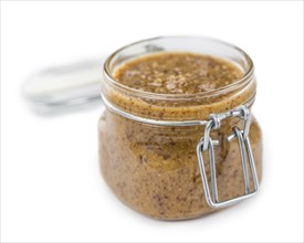 Portion of Sweet Mustard (as close-up shot) isolated on white background