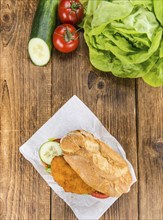 Chicken Schnitzel on a bun (selective focus, detailed close-up shot)