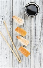 Portion of Sushi on a wooden table (selective focus, close-up shot)