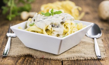 Porcini pasta on an old wooden table as detailed close-up shot, selective focus