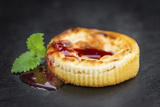 Cheesecake with Sauce on a vintage slate slab (close-up shot, selective focus)