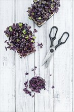 Fresh cutted Cress as high detailed close-up shot on a vintage wooden table (selective focus)