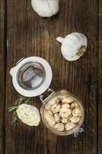 Fresh made Garlic (preserved) on a vintage background (close-up shot)