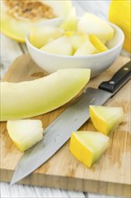 Fresh made Yellow Honeydew Melon on a vintage background (close-up shot)