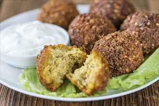 Homemade Falafel (close-up shot, selective focus) on wooden background