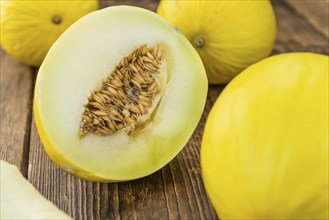 Fresh made Yellow Honeydew Melon on a vintage background (close-up shot)