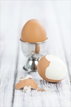 Some boiled Eggs (close-up shot, selective focus) on an old wooden table