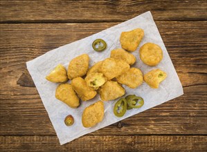 Chili Cheese Nuggets on a vintage background as detailed close-up shot (selective focus)