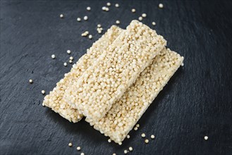 Some Quinoa Bars on a slate slab (close-up shot, selective focus)