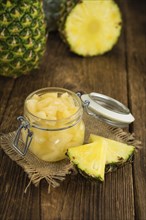 Preserved Pineapple pieces on a vintage background as detailed close-up shot, selective focus