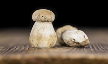 Fresh Porcinis on an old wooden table (close-up shot, selective focus)