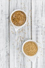 Homemade Sweet Mustard on an wooden table (selective focus) as detailed close-up shot