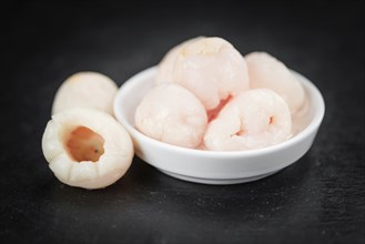 Fresh made Lychees (preserved) on a vintage background (close-up shot)