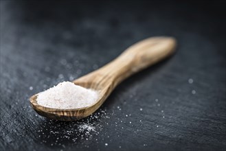 Pink Salt on a vintage background as detailed close-up shot (selective focus)